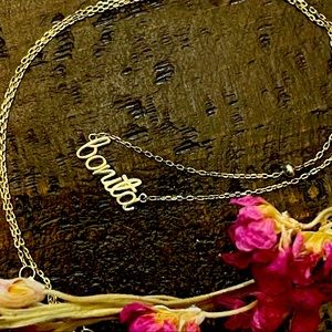 Gold Bonita nameplate necklace in sterling silver. Cursive Word pendant